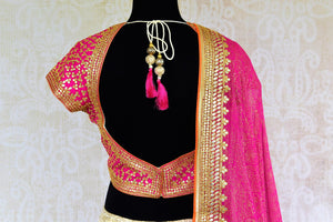 Buy pink and cream embroidered lehenga choli online from Pure Elegance with dupatta. Our Indian fashion store brings stunning desginer wedding lehengas in USA.-choli back
