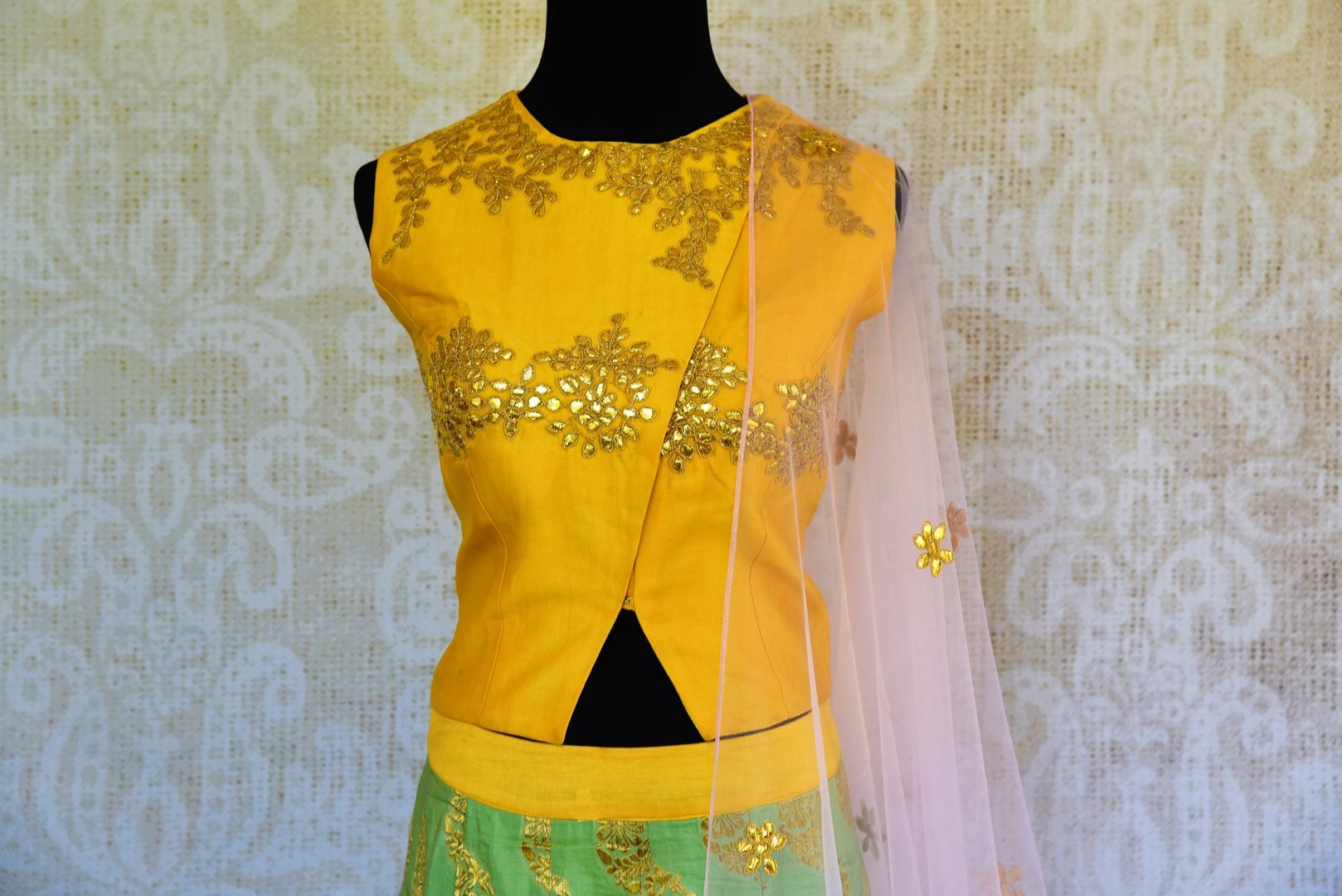 Buy yellow and green gota patti silk lehenga online in USA with dupatta. Pure Elegance fashion store brings a stunning range of Indian designer lehenga in USA for weddings.-choli