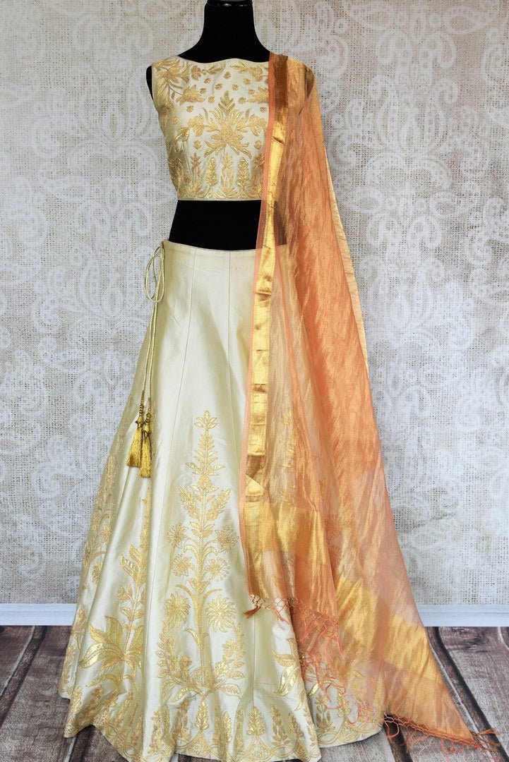 Buy beautiful cream embroidered silk lehenga choli set online in USA. The elegant attire is a perfect pick for an ethnic look at wedding and parties. Get floored by an exclusive collection of Indian designer lehengas in USA available at Pure Elegance fashion store or shop online.-full view