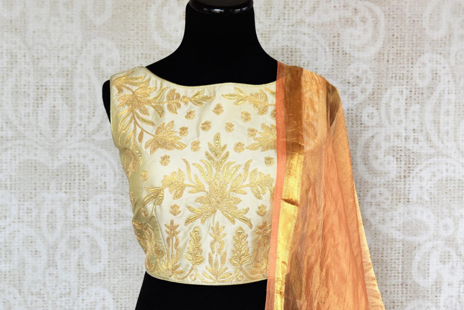 Buy beautiful cream embroidered silk lehenga choli set online in USA. The elegant attire is a perfect pick for an ethnic look at wedding and parties. Get floored by an exclusive collection of Indian designer lehengas in USA available at Pure Elegance fashion store or shop online.-front