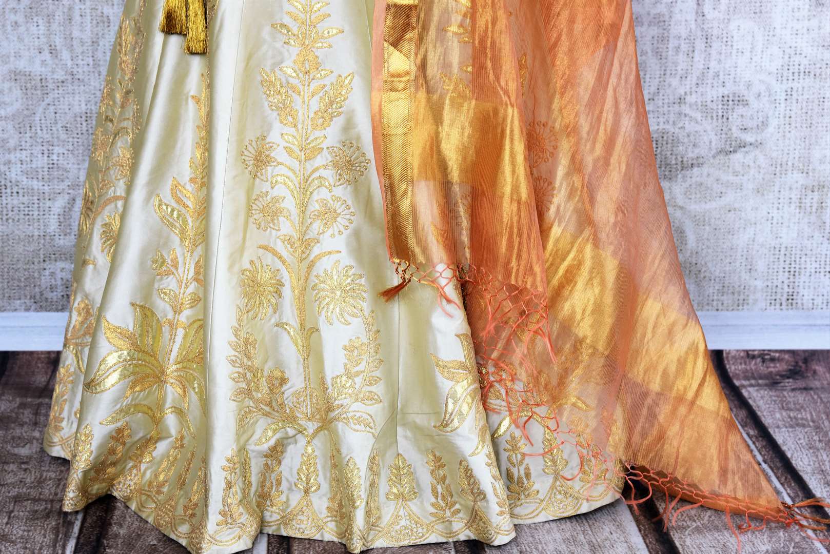 Buy beautiful cream embroidered silk lehenga choli set online in USA. The elegant attire is a perfect pick for an ethnic look at wedding and parties. Get floored by an exclusive collection of Indian designer lehengas in USA available at Pure Elegance fashion store or shop online.-skirt
