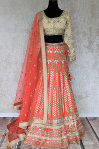 Shop the beautiful feminine coral raw silk embroidery lehenga with a cream silk embroidered blouse and peach sheer net dupatta to weddings. The authentically handcrafted silk lehenga will instantly glorify your look. Shop Indian dress online, designer lehenga online or visit Pure Elegance store in USA. -full view