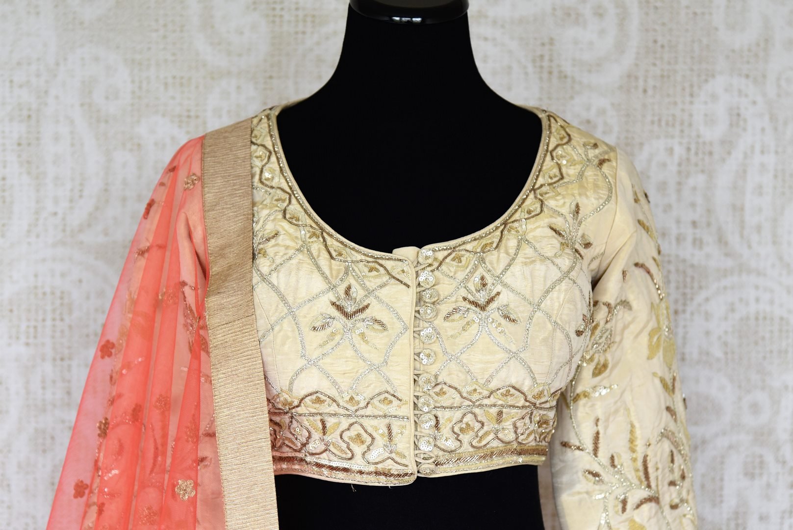 Shop the beautiful feminine coral raw silk embroidery lehenga with a cream silk embroidered blouse and peach sheer net dupatta to weddings. The authentically handcrafted silk lehenga will instantly glorify your look. Shop Indian dress online, designer lehenga online or visit Pure Elegance store in USA. - blouse pallu