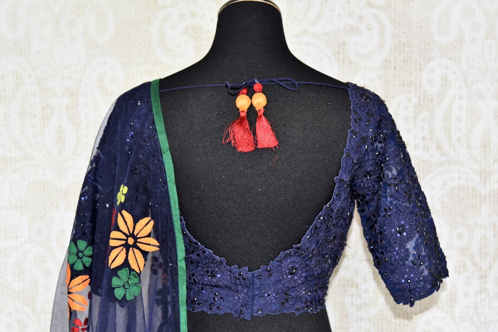 Amaze everyone as you step the aisle in this designer royal blue silk applique work lehenga with a floral blue dupatta. Channel the inner diva as you embrace the embroidered blouse and complete the look with utmost grace and poise. Shop designer Indian dress,Anarkali, lehengas online or visit Pure Elegance store, USA. -blouse back