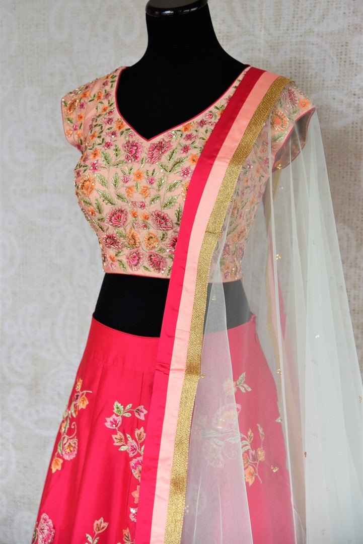 Buy beautiful pink embroidered silk lehenga with dupatta online in USA . The designer lehenga is a captivating choice for weddings. Shop Indian wedding lehengas in USA from an alluring collection available at Pure Elegance clothing store.-side view