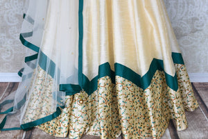 Splurge on this designer cream silk net embroidery lehenga with cream-coloured dupatta to look nothing less than a dream. Escalate your style appeal with the emerald-hued blouse embroidered to perfection and drape the dupatta. Shop beautifully handcrafted lehengas online or visit Pure Elegance store in USA. -lehenga skirt