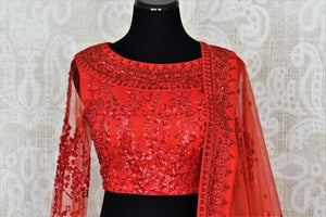 Buy red ticki work designer net lehenga with dupatta online in USA. Add brilliance to your Indian wedding look with an exquisite range of designer wedding lehengas available at Pure Elegance exclusive clothing store in USA or shop online.-blouse front