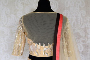 Grace this festive season with this meticulously crafted gold silk net embroidery lehenga with embellished sheer net dupatta. Bring flavour to your attire with this gorgeously handcrafted gold silk lehenga skirt. Shop graceful Indian dresses, designer silk saris, beautiful lehengas online or visit Pure Elegance in USA.-blouse back