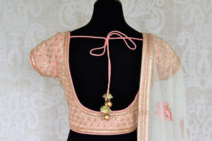 Look no less than a princess in this dreamy soft pink chanderi silk lehenga complemented with a pink zardozi embroidered blouse. A sheer net white embroidered dupatta to complete the look delicately falls on a side. Shop Indian dresses, lehenga choli, anarkali suit online or visit Pure Elegance store, USA.-blouse back