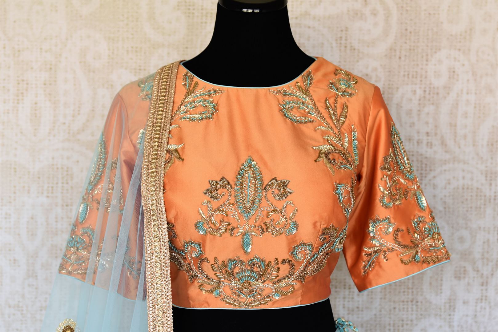 Doll up chic in this statement-worthy blue embroidery designer lehenga paired with contrasting orange embroidered designer blouse and buta work powder blue sheer net dupatta to add grace. Shop handcrafted designer dresses, indo-western dresses, lehengas online or visit Pure Elegance store in USA. -blouse
