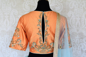 Doll up chic in this statement-worthy blue embroidery designer lehenga paired with contrasting orange embroidered designer blouse and buta work powder blue sheer net dupatta to add grace. Shop handcrafted designer dresses, indo-western dresses, lehengas online or visit Pure Elegance store in USA. -blouse back