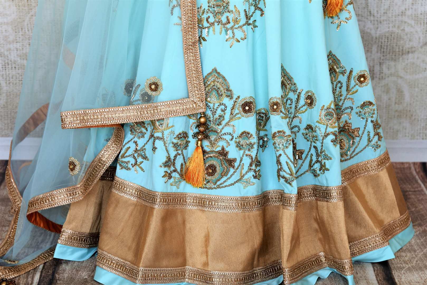 Doll up chic in this statement-worthy blue embroidery designer lehenga paired with contrasting orange embroidered designer blouse and buta work powder blue sheer net dupatta to add grace. Shop handcrafted designer dresses, indo-western dresses, lehengas online or visit Pure Elegance store in USA. -lehenga skirt