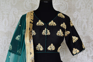 Heavily ornamented royal blue silk lehenga with checkered details and banarsi border comes with a gorgeous blue and beige silk embroidered blouse. Let the teal sequinned net dupatta fall immaculately for the feminine look. Shop designer sarees, lehenga cholis, Indian dresses online or visit Pure Elegance store, USA. -blouse front