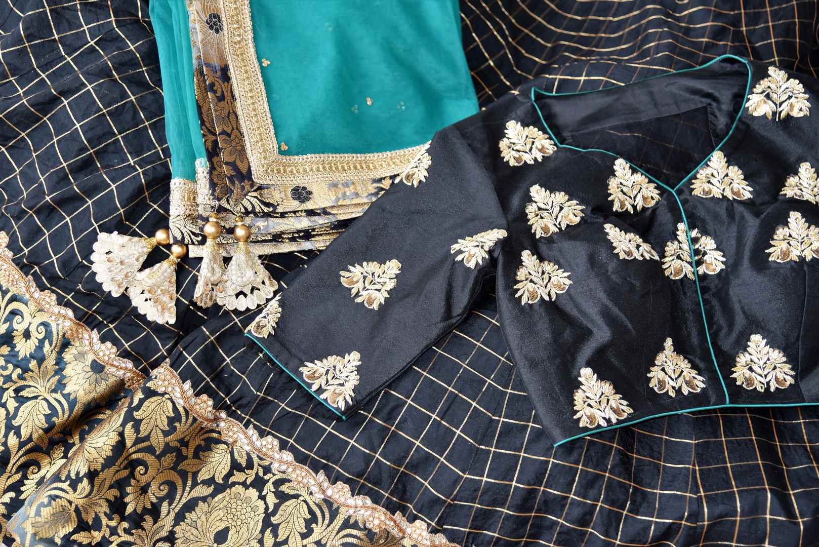 Heavily ornamented royal blue silk lehenga with checkered details and banarsi border comes with a gorgeous blue and beige silk embroidered blouse. Let the teal sequinned net dupatta fall immaculately for the feminine look. Shop designer sarees, lehenga cholis, Indian dresses online or visit Pure Elegance store, USA. -details