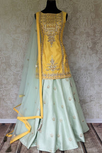 Wedding season calls for some serious indulgence and this mint green moti embroidery lehenga will not fail you. It comes with a bright yellow embroidered kurti. Drape the fancy mint green net dupatta on the side. Shop Indian dresses, anarkali suits, lehenga online or visit Pure Elegance store, USA. -full view