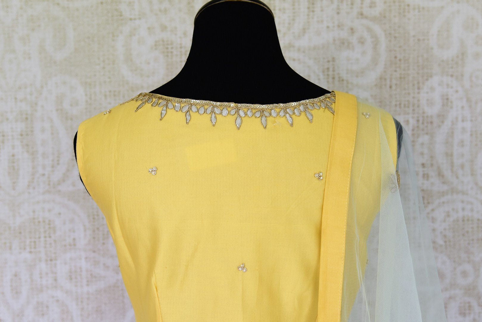Wedding season calls for some serious indulgence and this mint green moti embroidery lehenga will not fail you. It comes with a bright yellow embroidered kurti. Drape the fancy mint green net dupatta on the side. Shop Indian dresses, anarkali suits, lehenga online or visit Pure Elegance store, USA. -kurta back