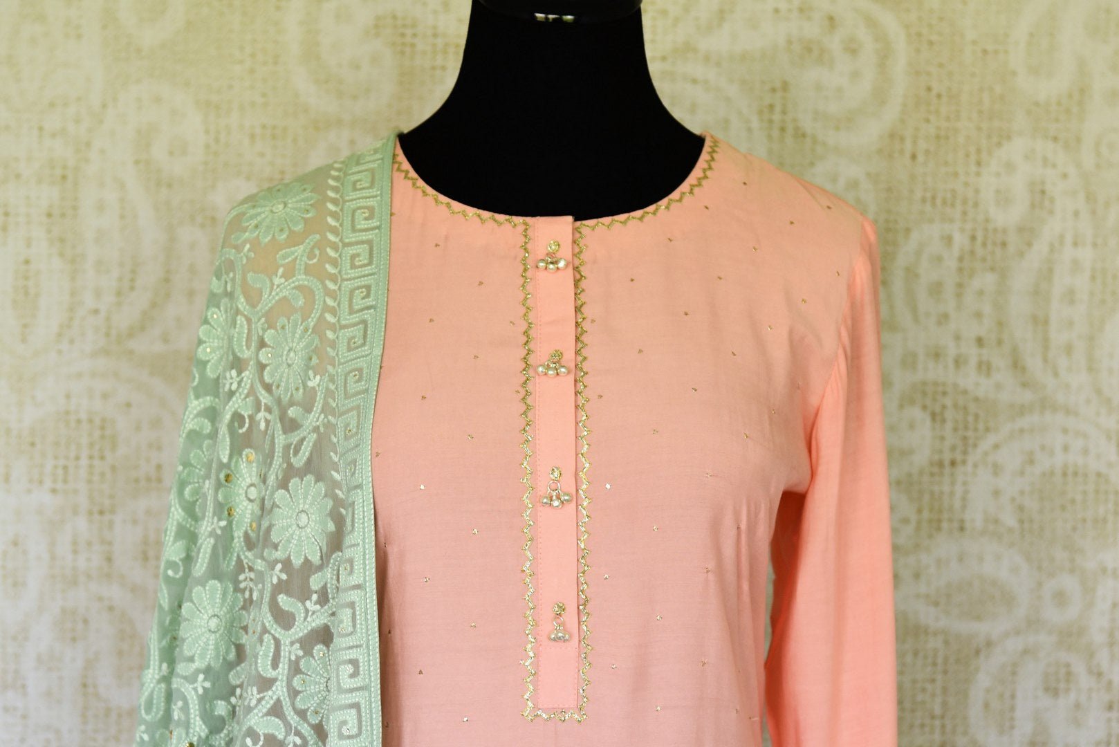 Sashay like a queen in this delicately handcrafted pink chanderi silk long kurta. The sequin work laden kurta is paired well with contrasting mint green skirt and chikankari dupatta to unveil the elegant you. Shop such designer silk sarees, anarkali suits, lehenga sets online or visit Pure Elegance store, USA.-kurta front