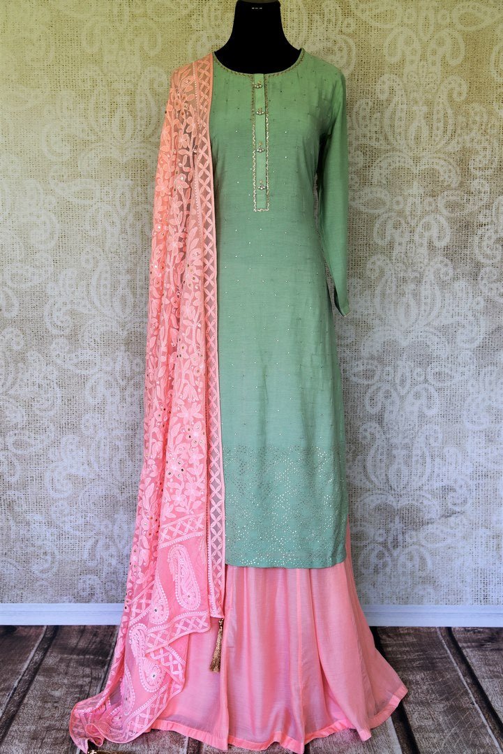 Ooze an oomph in this mint green chanderi silk sequin work long kurta. The beautifully handcrafted kurta is styled with contrasting pink flowy silk skirt. Drape the pleasing pink chikankari dupatta to complete the look. Shop designer suits, lehenga sets, Indian dresses online or visit Pure Elegance store,USA. -full view