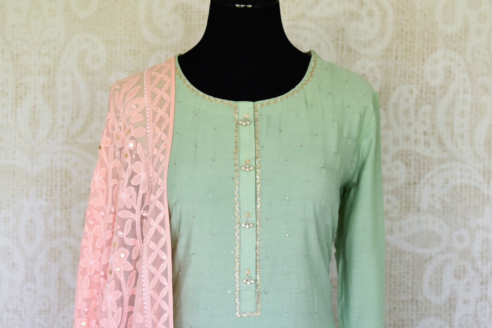 Ooze an oomph in this mint green chanderi silk sequin work long kurta. The beautifully handcrafted kurta is styled with contrasting pink flowy silk skirt. Drape the pleasing pink chikankari dupatta to complete the look. Shop designer suits, lehenga sets, Indian dresses online or visit Pure Elegance store,USA. -kurta front