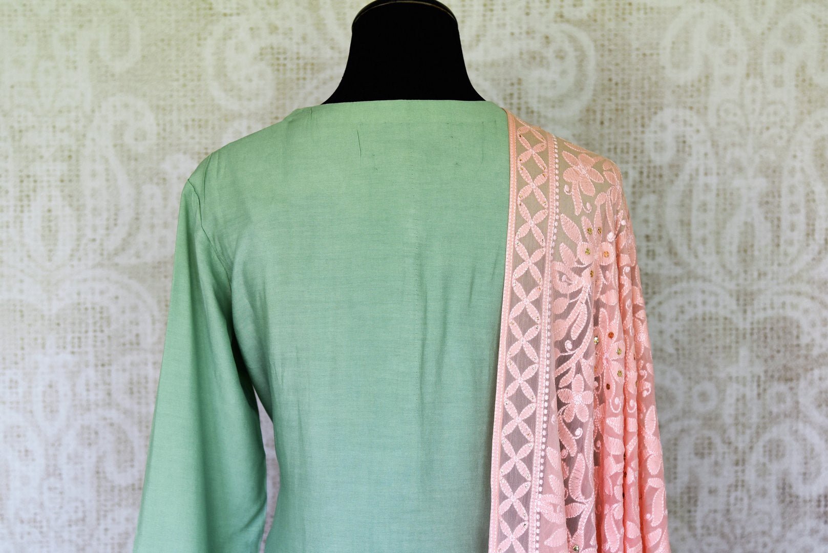 Ooze an oomph in this mint green chanderi silk sequin work long kurta. The beautifully handcrafted kurta is styled with contrasting pink flowy silk skirt. Drape the pleasing pink chikankari dupatta to complete the look. Shop designer suits, lehenga sets, Indian dresses online or visit Pure Elegance store,USA. -kurta back