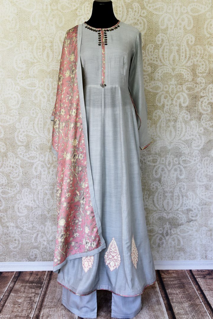 Indulge in a pretty and feminine grey silk long straight kurta. Complement the attire with a pair of open wide trousers and add a beautiful peach floral dupatta over it. U Shop exclusive sarees, anarkali suits, Indian dresses online or visit Pure Elegance store, USA. -full view
