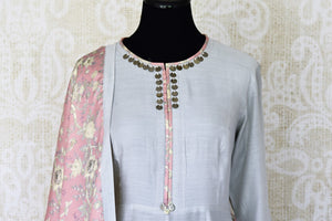 Indulge in a pretty and feminine grey silk long straight kurta. Complement the attire with a pair of open wide trousers and add a beautiful peach floral dupatta over it. U Shop exclusive sarees, anarkali suits, Indian dresses online or visit Pure Elegance store, USA. -kurta front