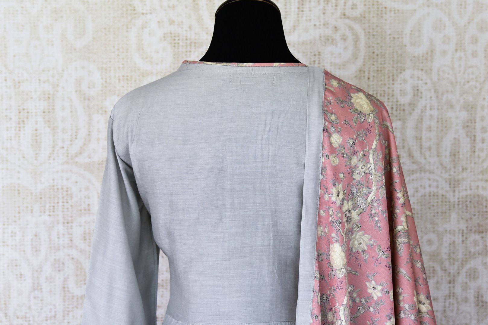 Indulge in a pretty and feminine grey silk long straight kurta. Complement the attire with a pair of open wide trousers and add a beautiful peach floral dupatta over it. U Shop exclusive sarees, anarkali suits, Indian dresses online or visit Pure Elegance store, USA. -kurta back
