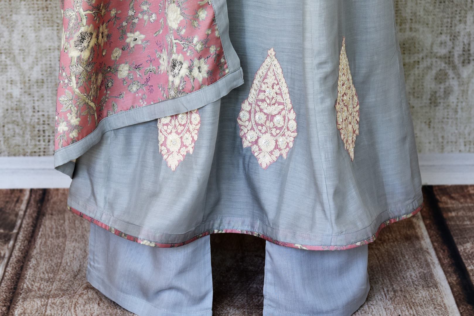 Indulge in a pretty and feminine grey silk long straight kurta. Complement the attire with a pair of open wide trousers and add a beautiful peach floral dupatta over it. U Shop exclusive sarees, anarkali suits, Indian dresses online or visit Pure Elegance store, USA. -salwar