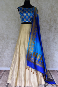 Buy gold Banarasi silk lehenga with blue sleeveless choli online in USA and dupatta. Find a range of stunning designer lehengas in USA at Pure Elegance Indian clothing store. Elevate your traditional style with a range of designer sarees, Indian clothing, and much more also available at our online store.-full view