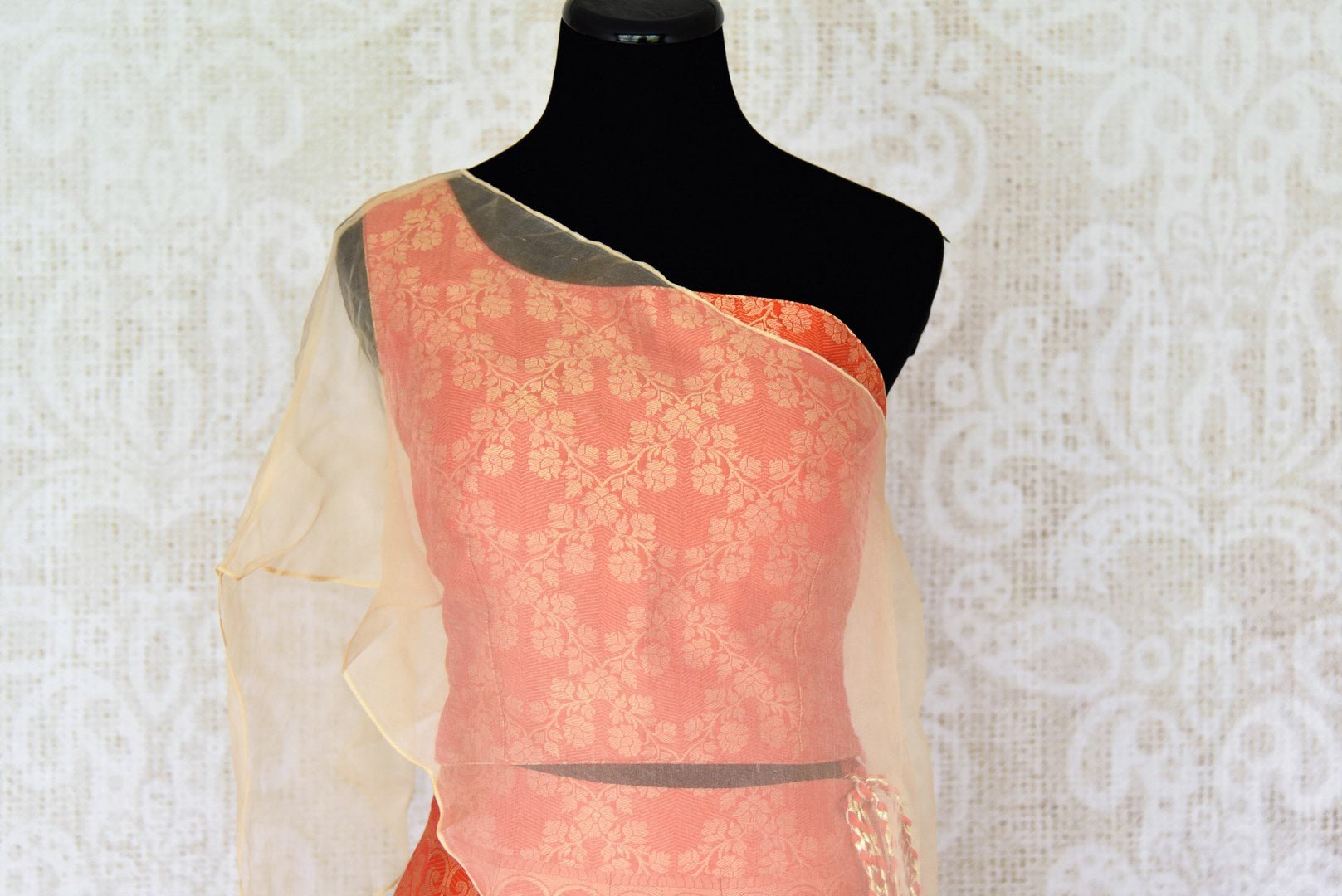 Shop orange Banarasi lehenga online in USA with organza overlay choli. Make every occasion special by choosing the best of designer dresses from Pure Elegance Indian clothing store in USA, Shop from a range of stunning designer lehengas, wedding dresses, Indowestern dresses from our online store.-blouse front
