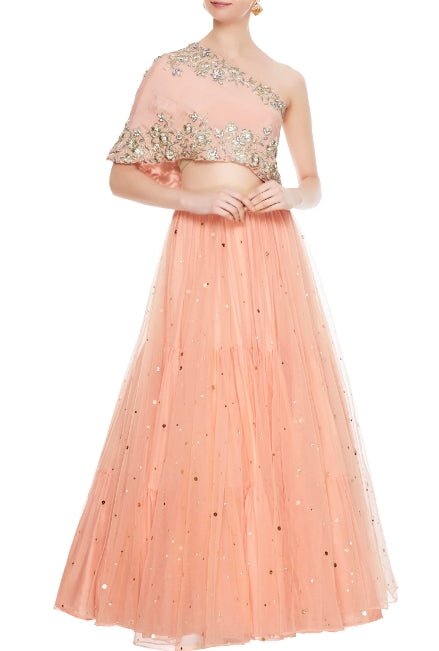 Buy peach net layered lehenga online in USA with embroidered one shoulder blouse. Add a flavor of glamor with an exclusive range of Indian formal dresses, designer lehengas, Indowestern dresses from Pure Elegance Indian fashion store in USA or shop online.-full view