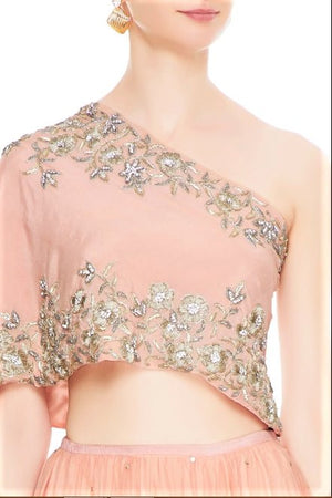 Buy peach net layered lehenga online in USA with embroidered one shoulder blouse. Add a flavor of glamor with an exclusive range of Indian formal dresses, designer lehengas, Indowestern dresses from Pure Elegance Indian fashion store in USA or shop online.-top