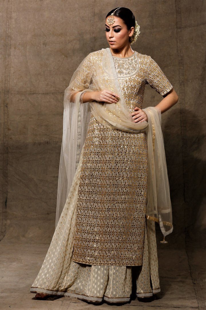 Buy beautiful ivory heavy gota patti kurta with skirt online in USA with net dupatta. Bring a rich traditional touch to your bridal look with beautiful Indian designer lehengas from Pure Elegance clothing store. We have a range of wedding lehengas, designer sarees, bridal saris in USA online and in our store. Shop now. -full view