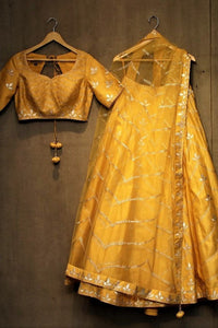 Shop yellow gota patti cotton chanderi lehenga online in USA. It comes with a matching choli and dupatta. Find more such exquisite designer lehengas at Pure Elegance online store. You can visit at our exclusive Indian clothing store in USA and shop from a range of beautiful Indian lehengas, wedding dresses, Anarkalis and much more.-full view