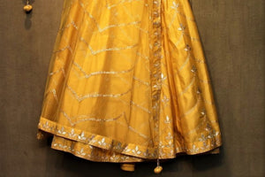 Shop yellow gota patti cotton chanderi lehenga online in USA. It comes with a matching choli and dupatta. Find more such exquisite designer lehengas at Pure Elegance online store. You can visit at our exclusive Indian clothing store in USA and shop from a range of beautiful Indian lehengas, wedding dresses, Anarkalis and much more.-lehenga
