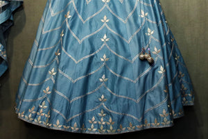 Buy blue cotton chanderi lehenga with gota patti embroidery online in USA. It comes with a matching choli and dupatta. Find more such exquisite designer lehengas at Pure Elegance online store. You can visit at our exclusive Indian clothing store in USA and shop from a range of beautiful Indian lehengas, wedding dresses...-lehenga