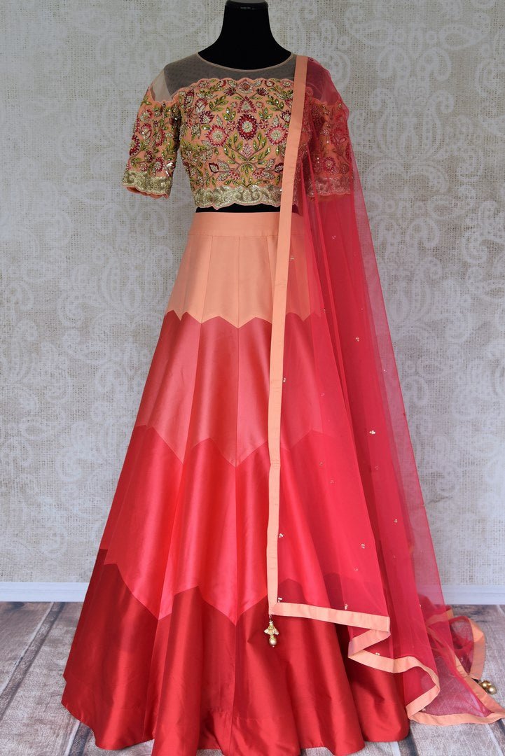 Buy peach carrot color silk lehenga with embroidered choli online in USA and dupatta. Find a range of stunning designer lehengas in USA at Pure Elegance Indian clothing store. Elevate your traditional style with a range of designer saris, Indian clothing, and much more also available at our online store.-full view