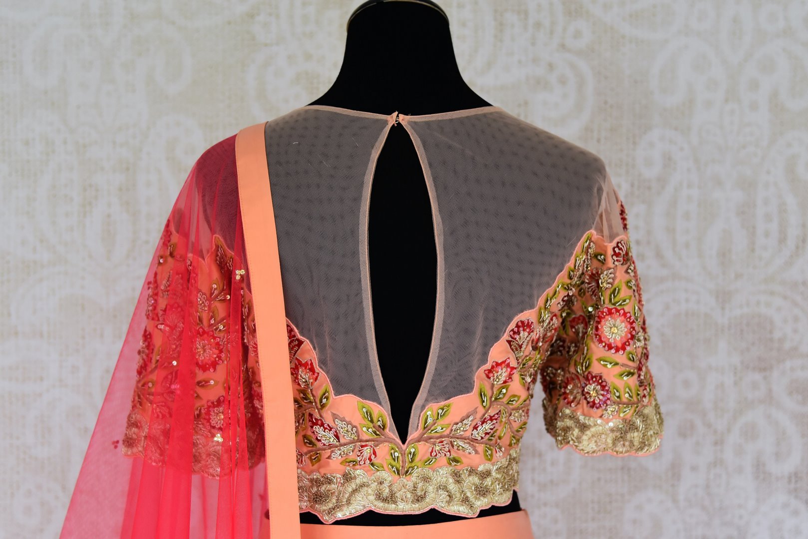 Buy peach carrot color silk lehenga with embroidered choli online in USA and dupatta. Find a range of stunning designer lehengas in USA at Pure Elegance Indian clothing store. Elevate your traditional style with a range of designer saris, Indian clothing, and much more also available at our online store.-blouse back