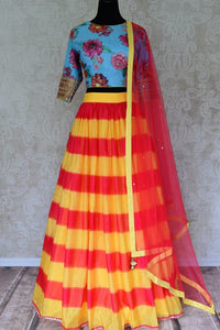 Buy yellow pink striped silk lehenga with blue floral print blouse online in USA and dupatta. Find a range of stunning designer lehengas in USA at Pure Elegance Indian clothing store. Elevate your traditional style with a range of designer saris, Indian clothing, and much more also available at our online store.-full view
