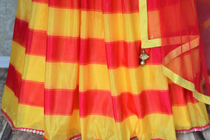 Buy yellow pink striped silk lehenga with blue floral print blouse online in USA and dupatta. Find a range of stunning designer lehengas in USA at Pure Elegance Indian clothing store. Elevate your traditional style with a range of designer saris, Indian clothing, and much more also available at our online store.-skirt