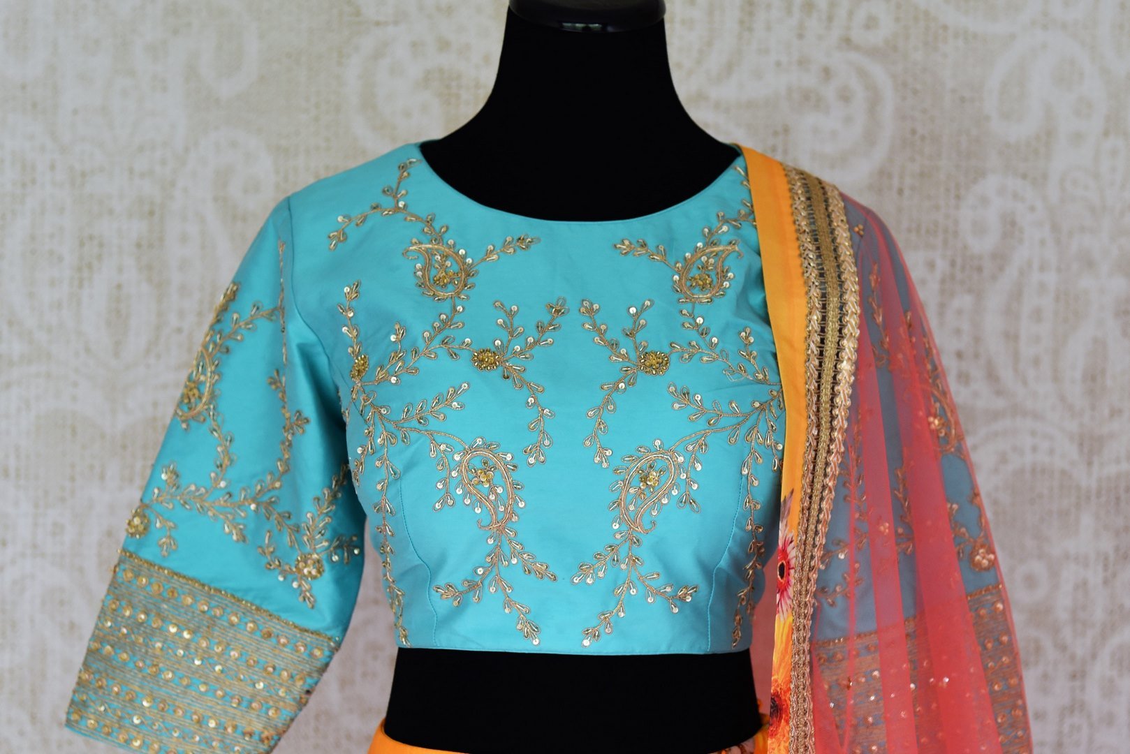 Buy yellow floral silk lehenga with blue embroidered blouse online in USA and dupatta. Find a range of stunning designer lehengas in USA at Pure Elegance Indian clothing store. Elevate your traditional style with a range of designer saris, Indian clothing, and much more also available at our online store.-blouse front