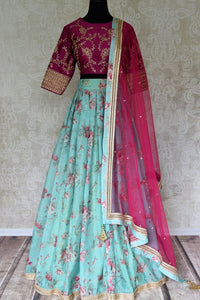 Shop blue floral silk lehenga with magenta embroidered blouse online in USA and dupatta. Find a range of stunning designer lehengas in USA at Pure Elegance Indian clothing store. Elevate your traditional style with a range of designer saris, Indian clothing, and much more also available at our online store.-full view