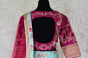 Shop blue floral silk lehenga with magenta embroidered blouse online in USA and dupatta. Find a range of stunning designer lehengas in USA at Pure Elegance Indian clothing store. Elevate your traditional style with a range of designer saris, Indian clothing, and much more also available at our online store.-blouse back