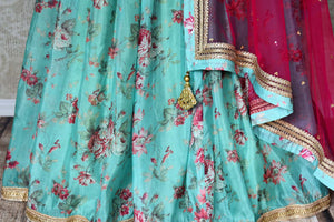 Shop blue floral silk lehenga with magenta embroidered blouse online in USA and dupatta. Find a range of stunning designer lehengas in USA at Pure Elegance Indian clothing store. Elevate your traditional style with a range of designer saris, Indian clothing, and much more also available at our online store.-skirt