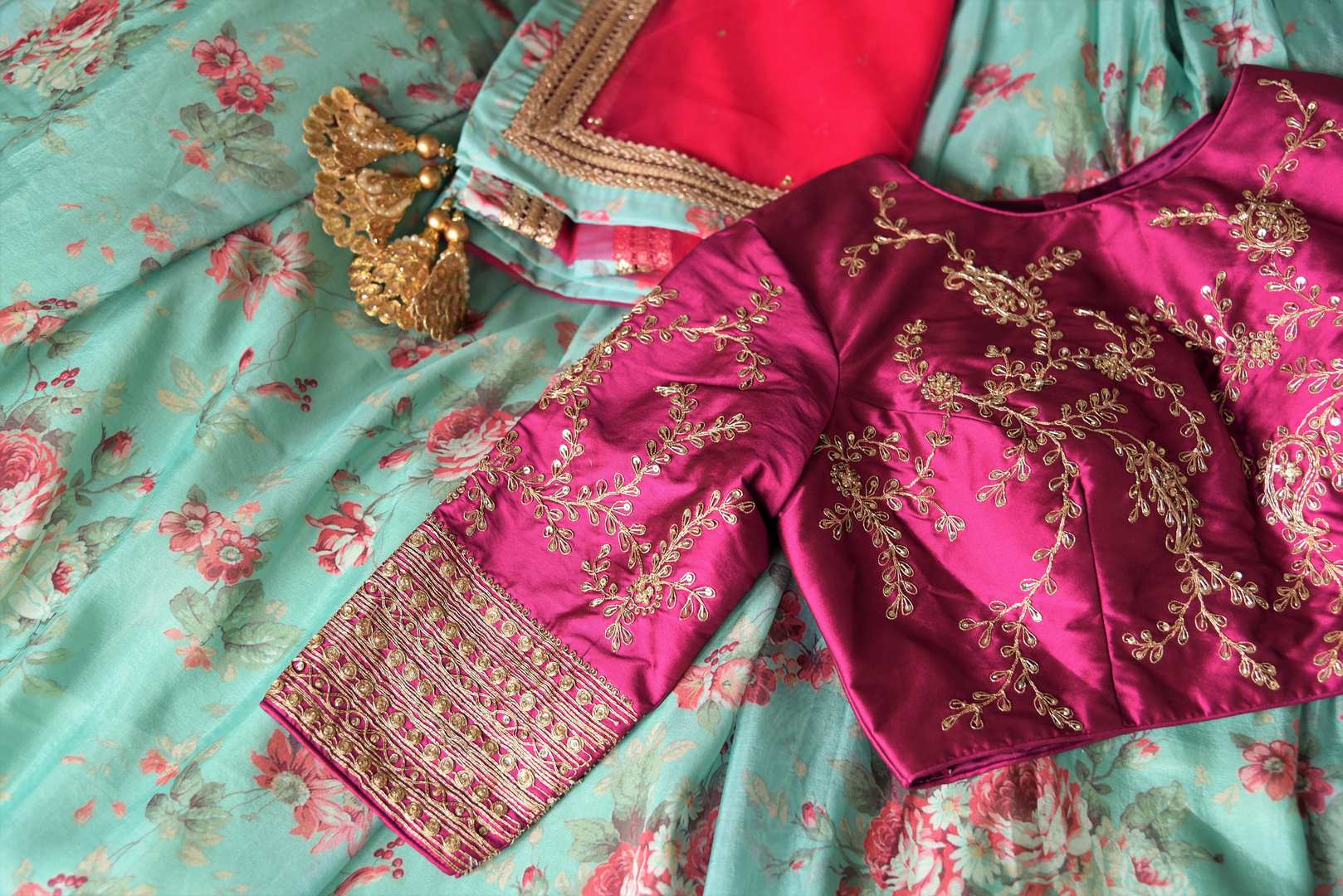 Shop blue floral silk lehenga with magenta embroidered blouse online in USA and dupatta. Find a range of stunning designer lehengas in USA at Pure Elegance Indian clothing store. Elevate your traditional style with a range of designer saris, Indian clothing, and much more also available at our online store.-details