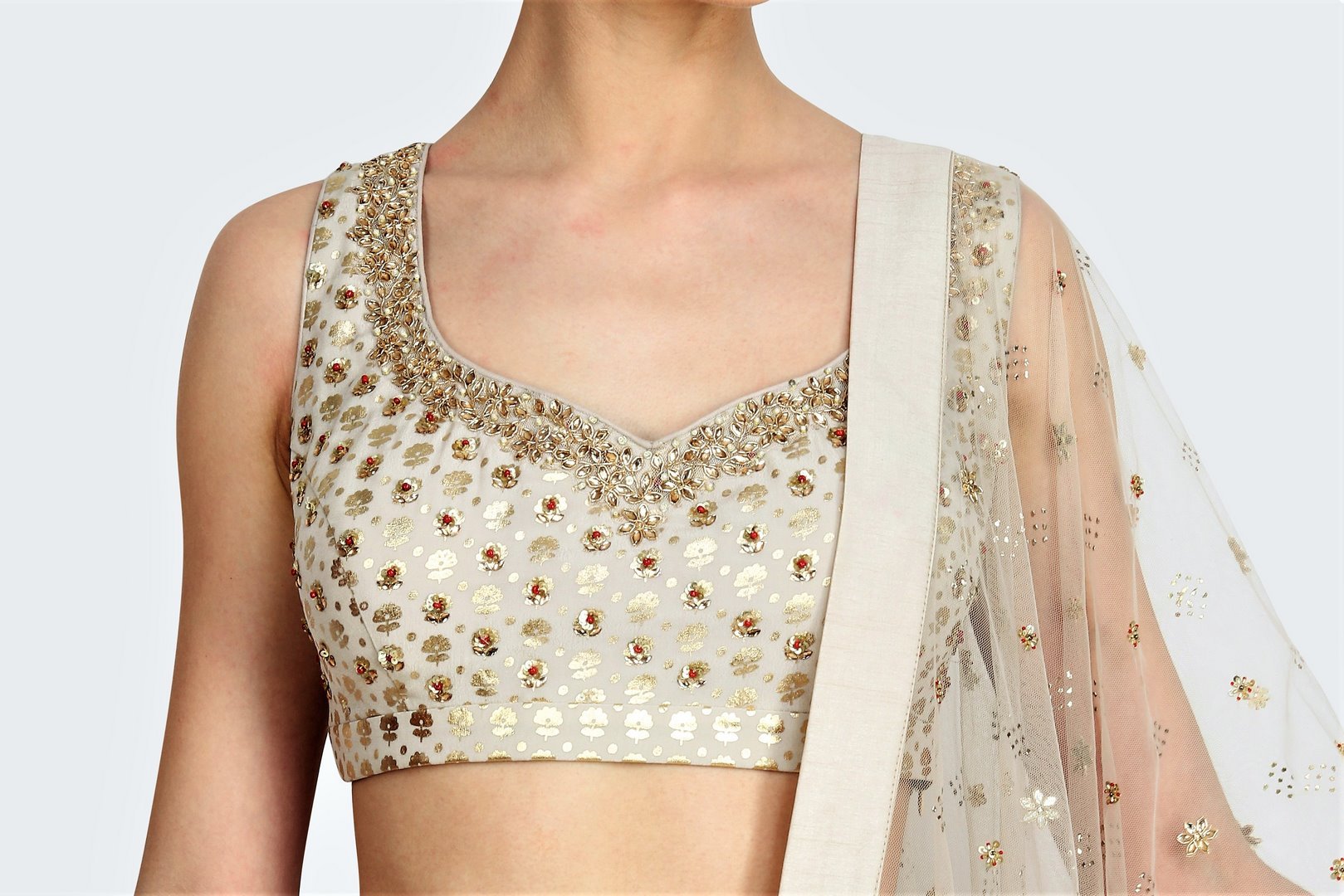 Shop off-white foil print lehenga online in USA with mukesh net dupatta. For more such gorgeous designer lehengas, shop at Pure Elegance Indian fashion store in USA. A beautiful range of traditional sarees and clothing is available for Indian women living in USA. You can also shop at our online store.-blouse