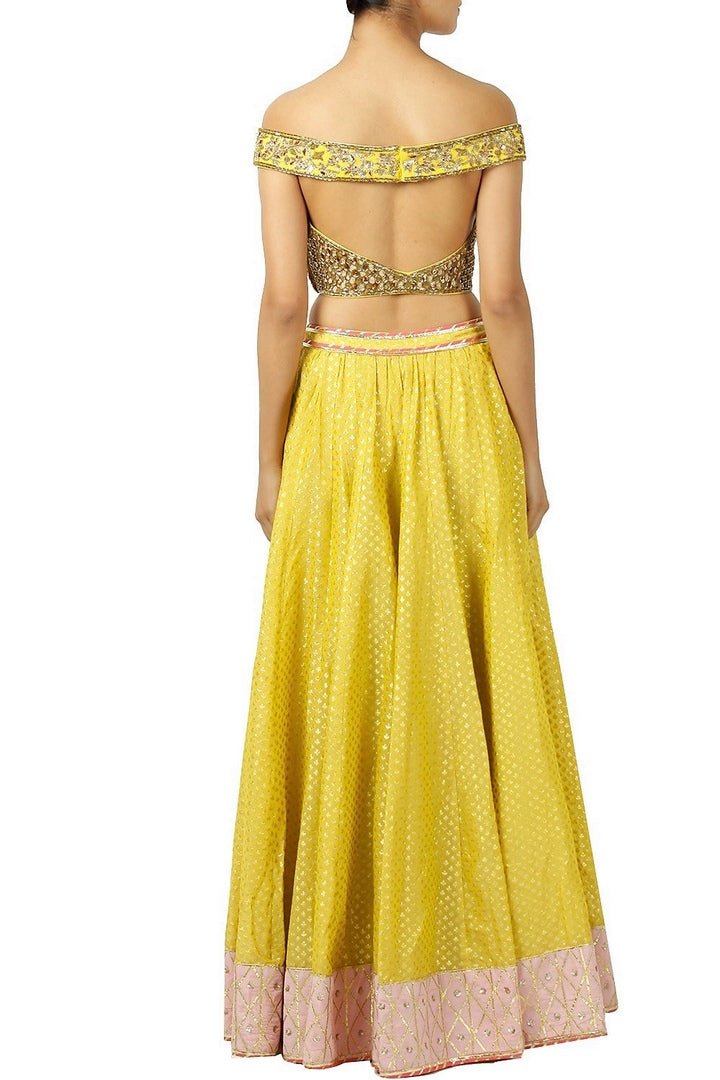 Buy yellow color embroidered lehenga online in USA with off shoulder blouse. Find a range of Indian wedding dresses for brides at Pure Elegance clothing store in USA. Keep your ethnic look perfect with a range of traditional Indian clothing, designer silk saris, wedding saris and much more also available at our online store.-back