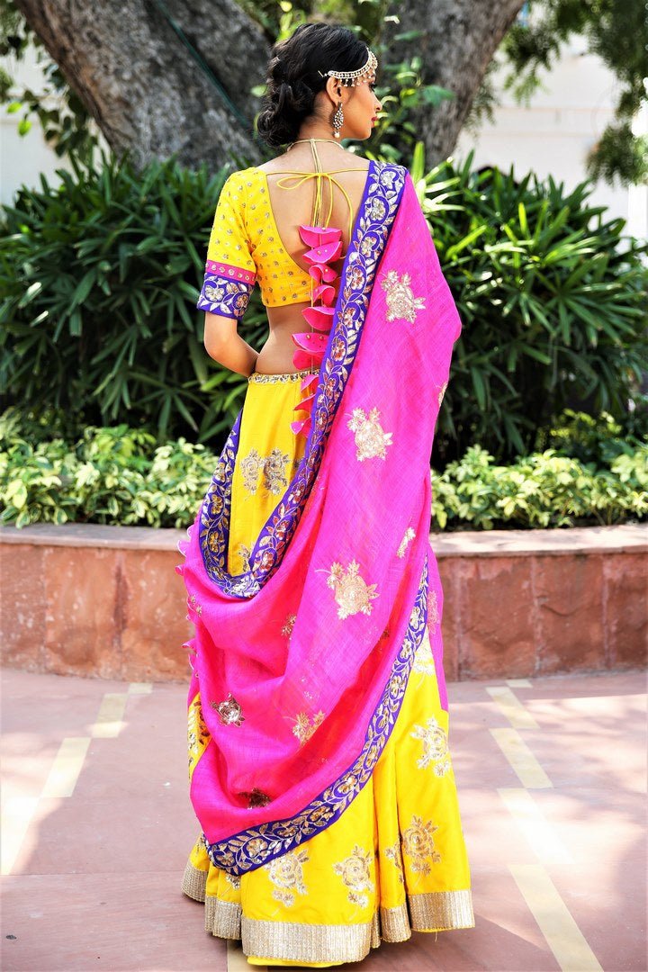 Buy turmeric yellow embroidered dupion lehenga with pink dupatta online in USA. Get wedding ready with a stunning range of Indian designer lehengas from Pure Elegance fashion store in USA. Shop from a collection of silk sarees, wedding sarees, Banarasi sarees, and Indian clothing for a gorgeous ethnic look.-back
