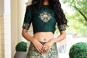 Buy deep green dupion crop top with Banarasi kalidaar skirt online in USA. Get wedding ready with a stunning range of Indian designer lehengas from Pure Elegance fashion store in USA. Shop from a collection of silk sarees, wedding sarees, Banarasi sarees, and Indian clothing for a gorgeous ethnic look.-crop top