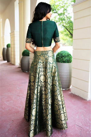 Buy deep green dupion crop top with Banarasi kalidaar skirt online in USA. Get wedding ready with a stunning range of Indian designer lehengas from Pure Elegance fashion store in USA. Shop from a collection of silk sarees, wedding sarees, Banarasi sarees, and Indian clothing for a gorgeous ethnic look.-back